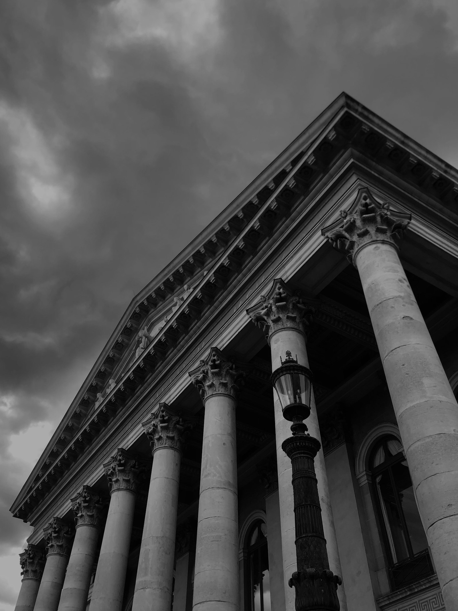 Black-and-white view up the columns and pediment of a neoclassical building